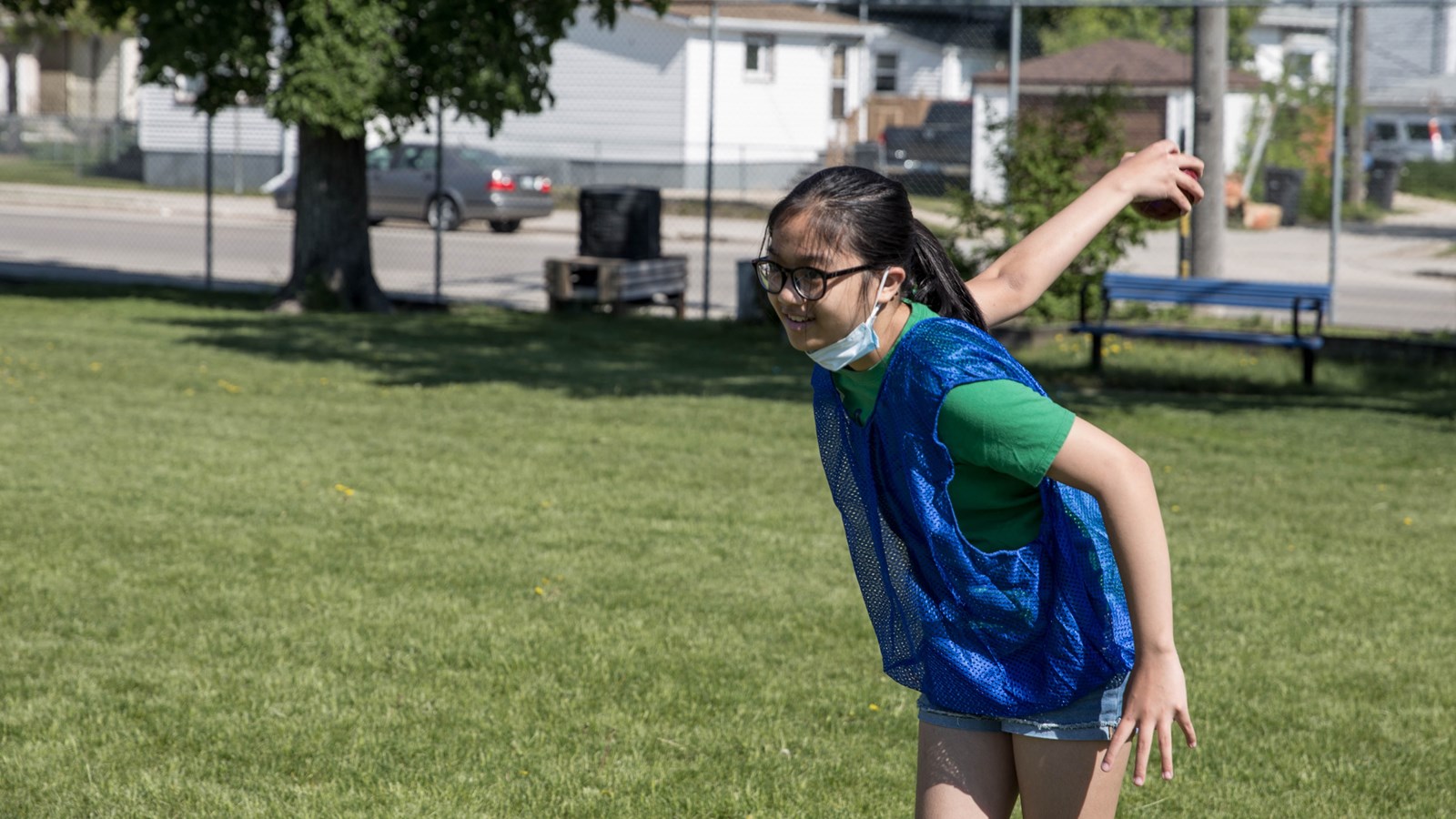 A student plays bocce ball on the Greenway field.